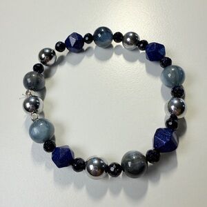 Deep blue bracelet with cat’s eye, metallic beads, and faceted dark crystals.
